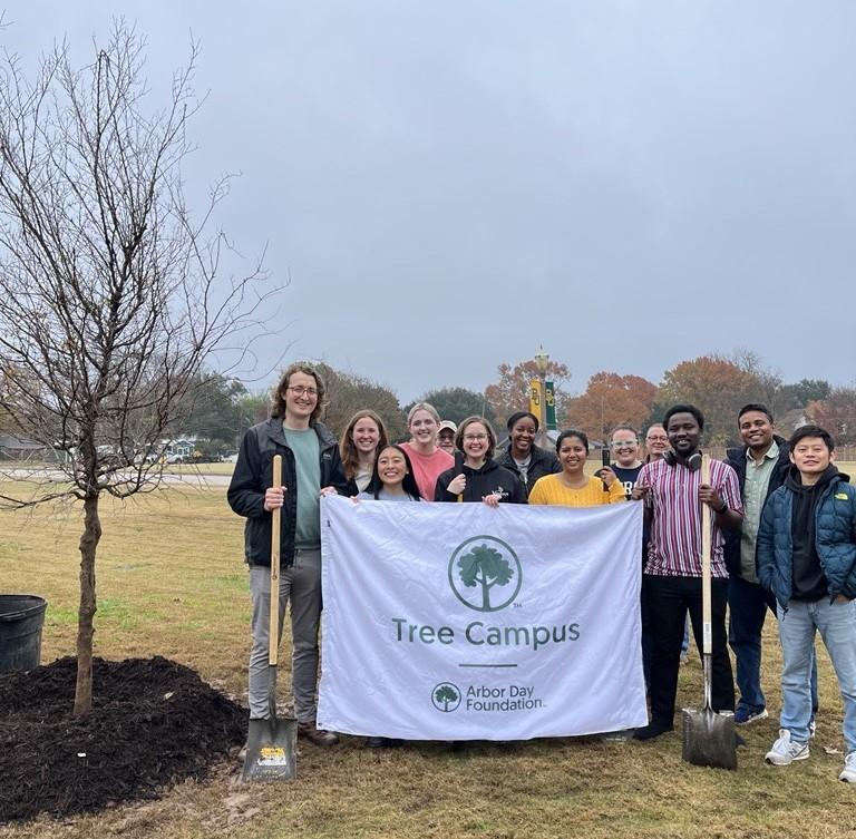 BU-SETAC students holding Tree Campus banner